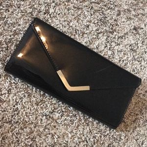 Black patent evening clutch with gold detail